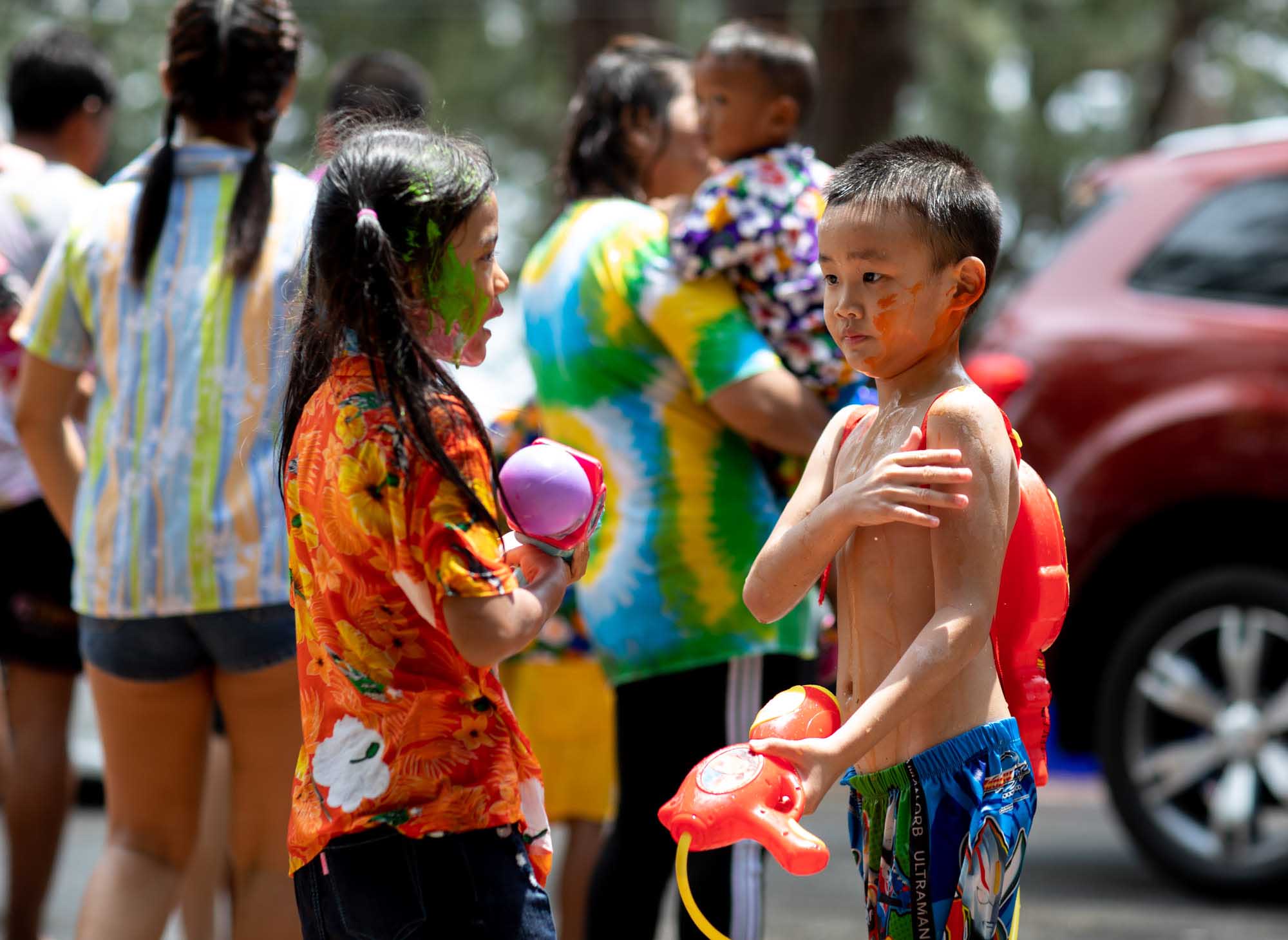 Two young kids with painted faces on Songkran water festival in Phuket, Thailand