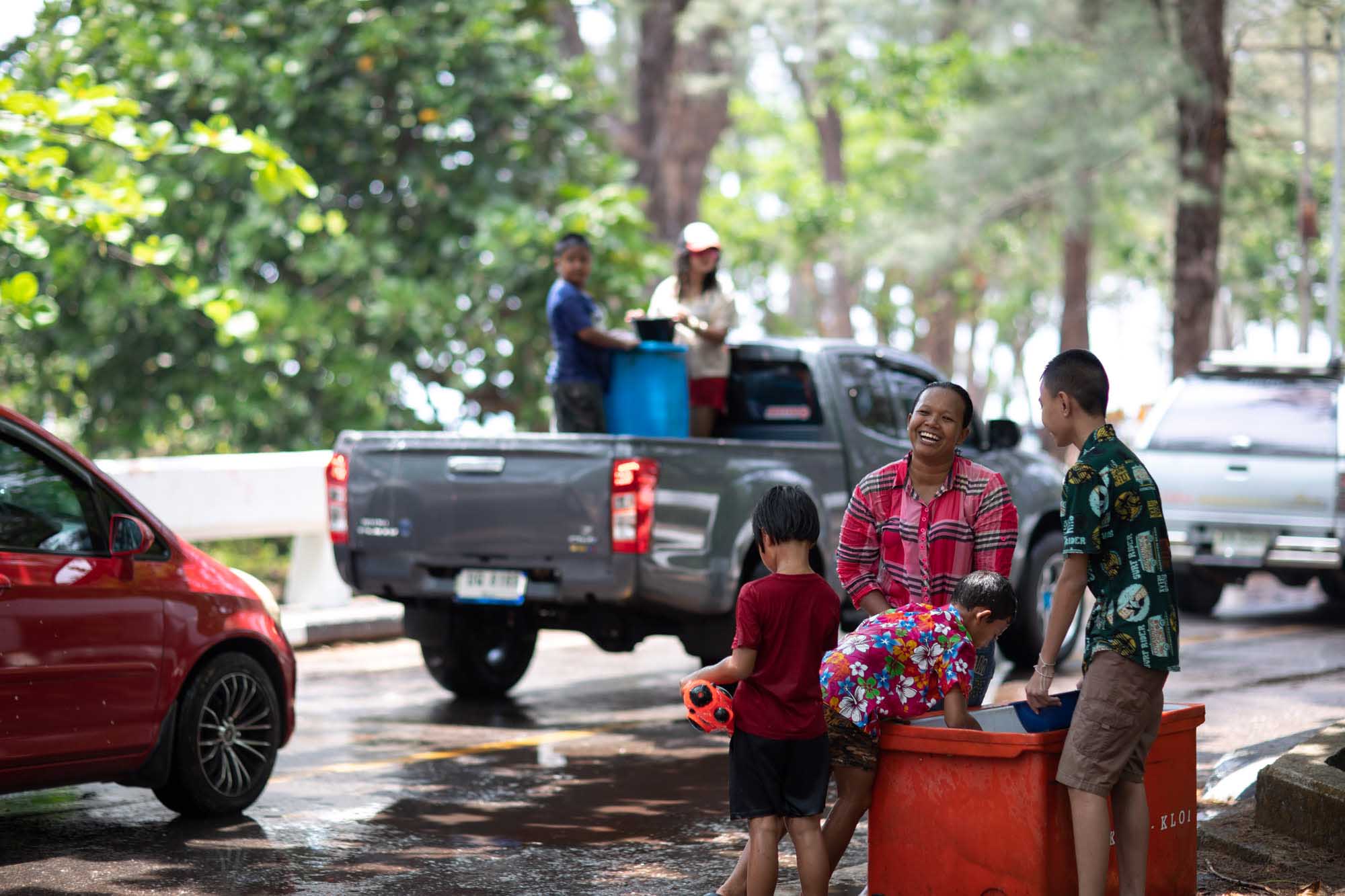 Happy people celebrating Songkran water festival in Phuket, Thailand