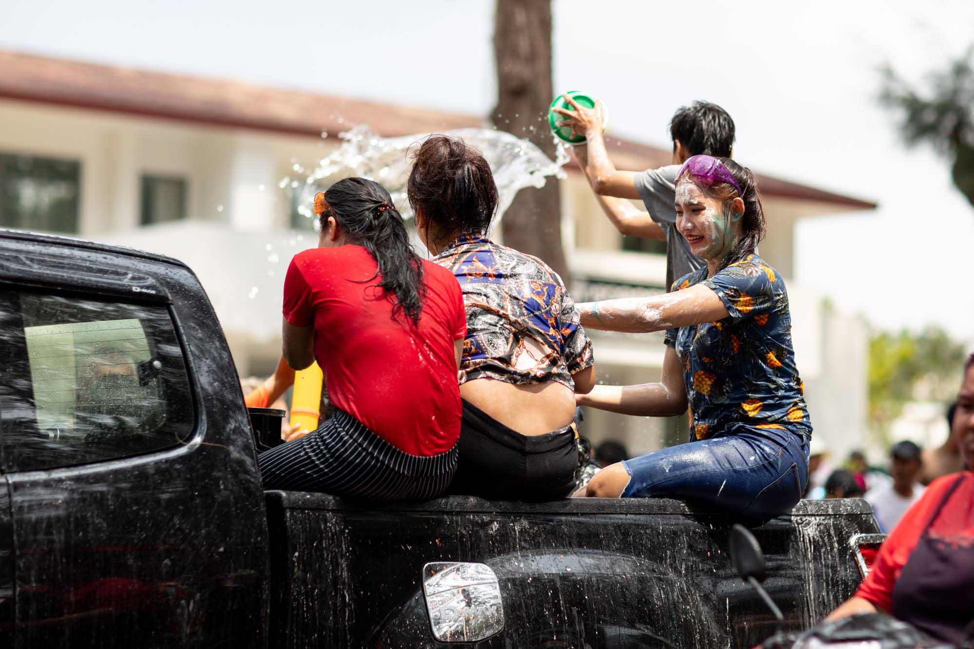 Women covered in paint during Songkran water festival in Phuket, Thailand