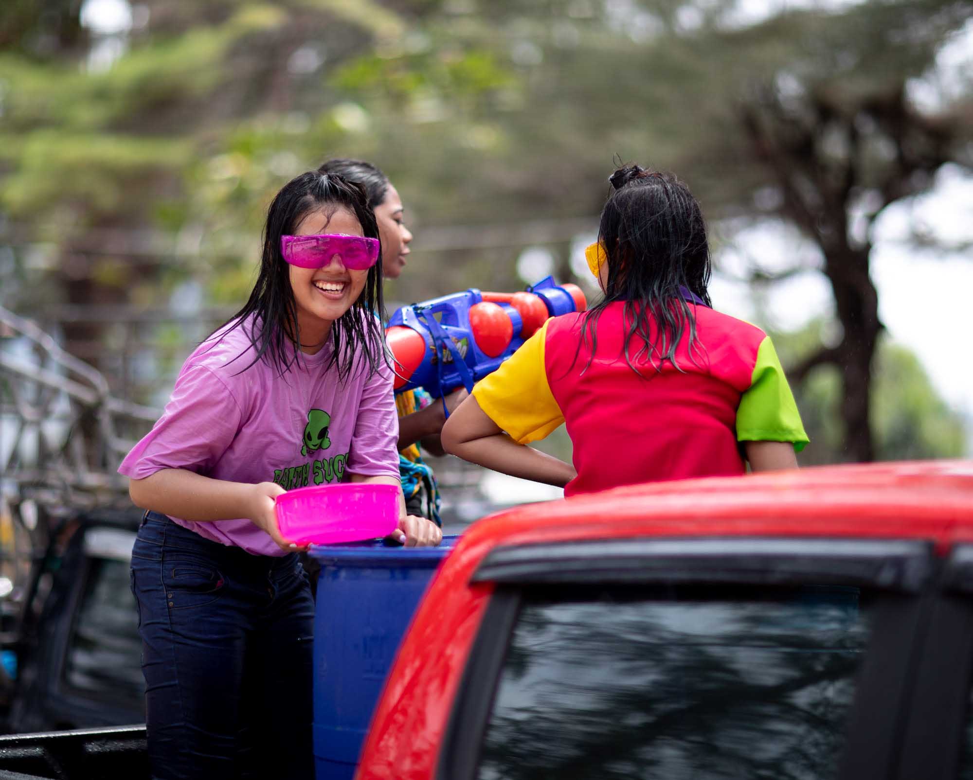 Woman having fun at Songkran water festival in Phuket, Thailand