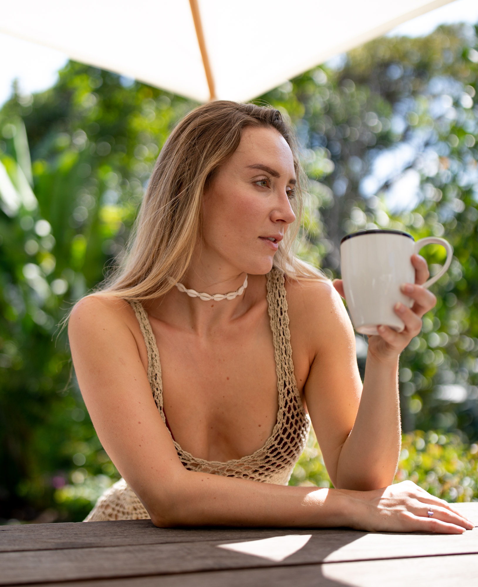 Blonde woman drinks cup of coffee outdoor on sunny day | Swimwear | Lifestyle Photography | Canggu, Bali, Indonesia