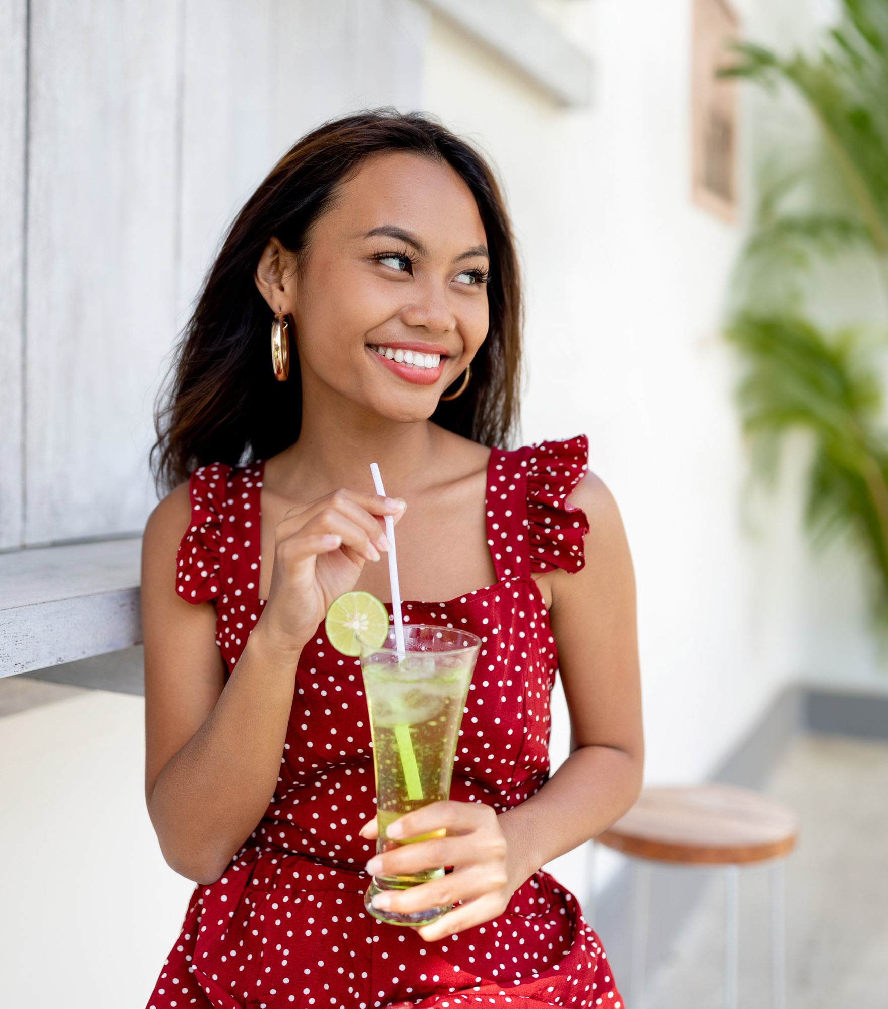 Woman drinks cocktail on a sunny day in bali while wearing red | Lifestyle Photography | Swimwear Photography | Asian Bali Model | High Key Photography | Fashion Photography