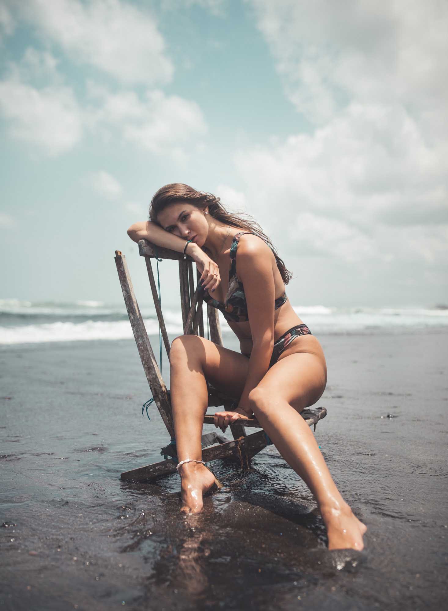 Beautiful woman in bikini models on an abandoned chair on the beach | Fashion Photography | Portrait | Lifestyle Photography | Pantai Mangening,Bali, Indonesia | Swimwear | Sexy | Hot | Denver Photographer |