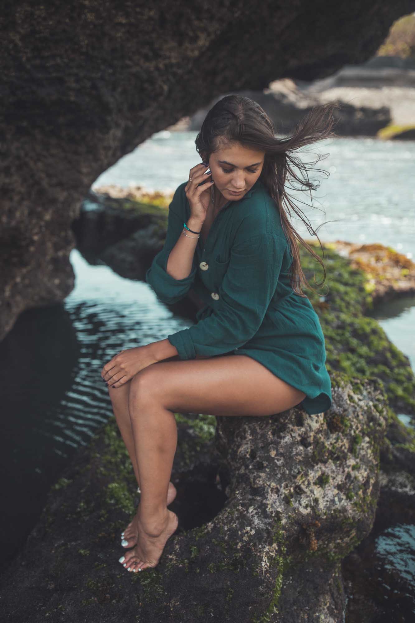 Woman in green button up dress models near a tide pool | Fashion Photography | Portrait | Lifestyle Photography | Pantai Mangening, Canggu ,Bali, Indonesia | Denver Photographer