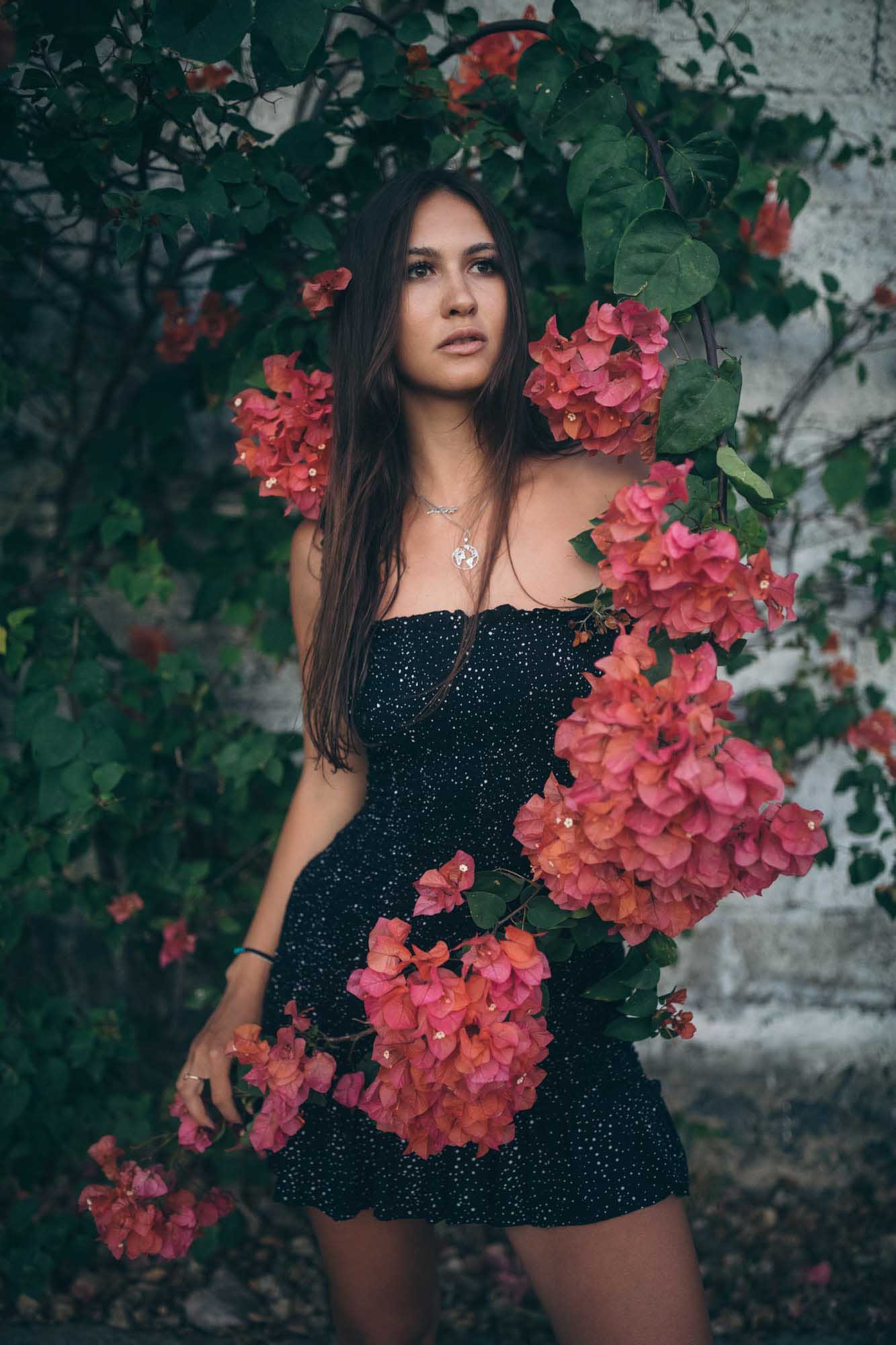 Woman in black dress poses with red flowers | Fashion Photography | Portrait | Lifestyle Photography | Canggu ,Bali, Indonesia  | Denver Photographer
