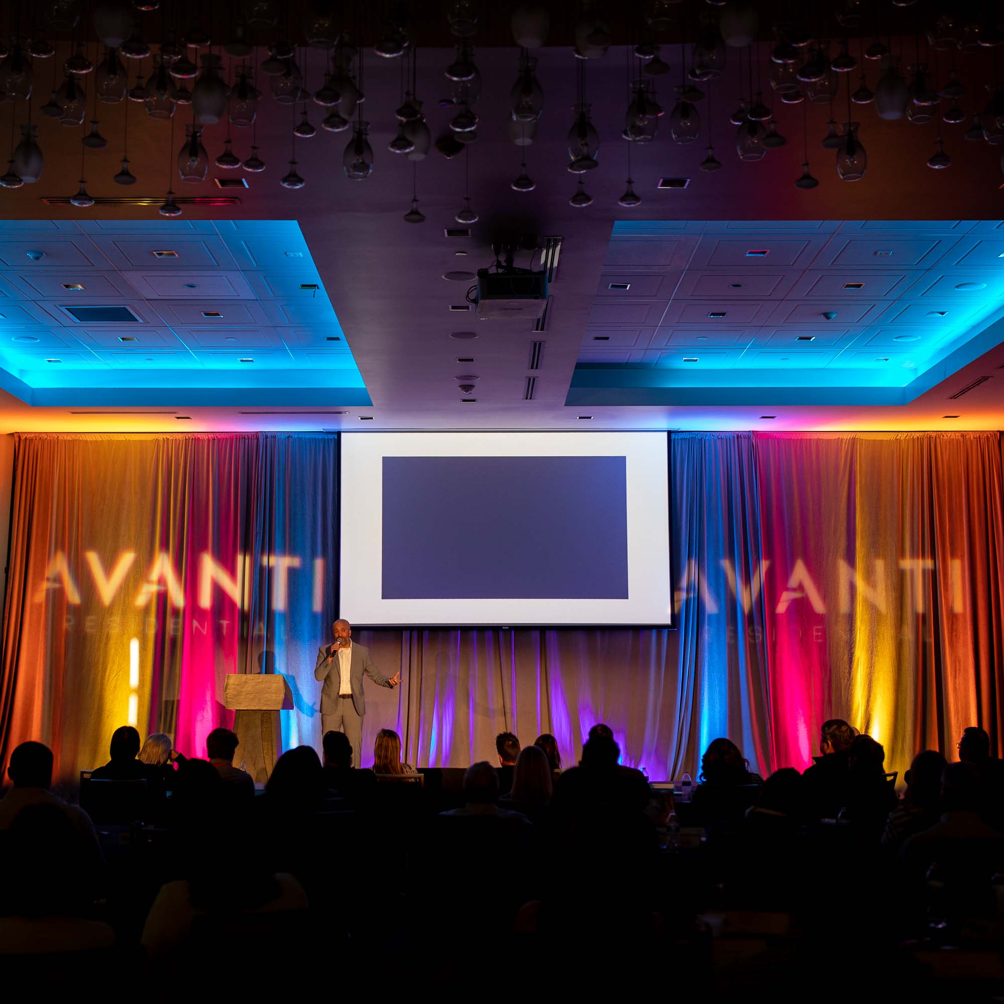 Executive gives speech on stage | Event Photographer Denver