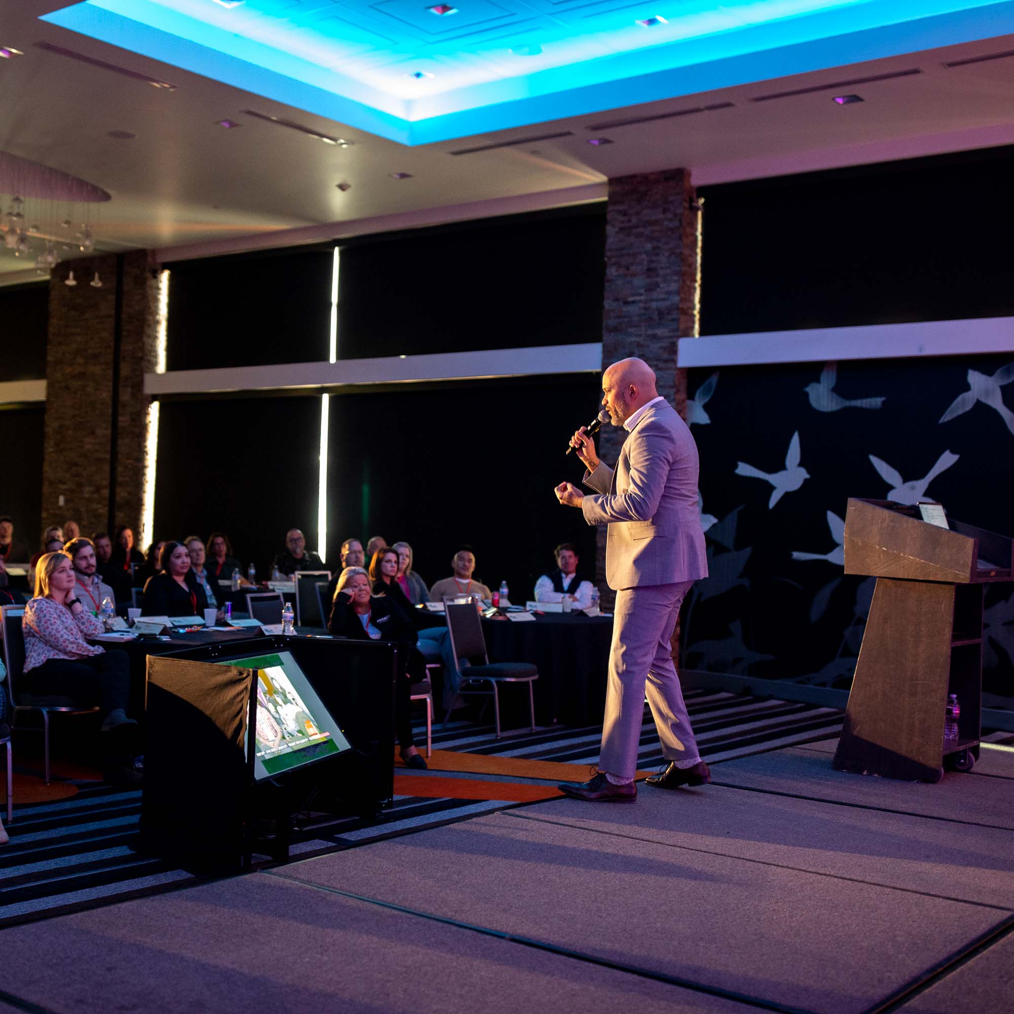 Man gives a speech on stage | Event photography Denver