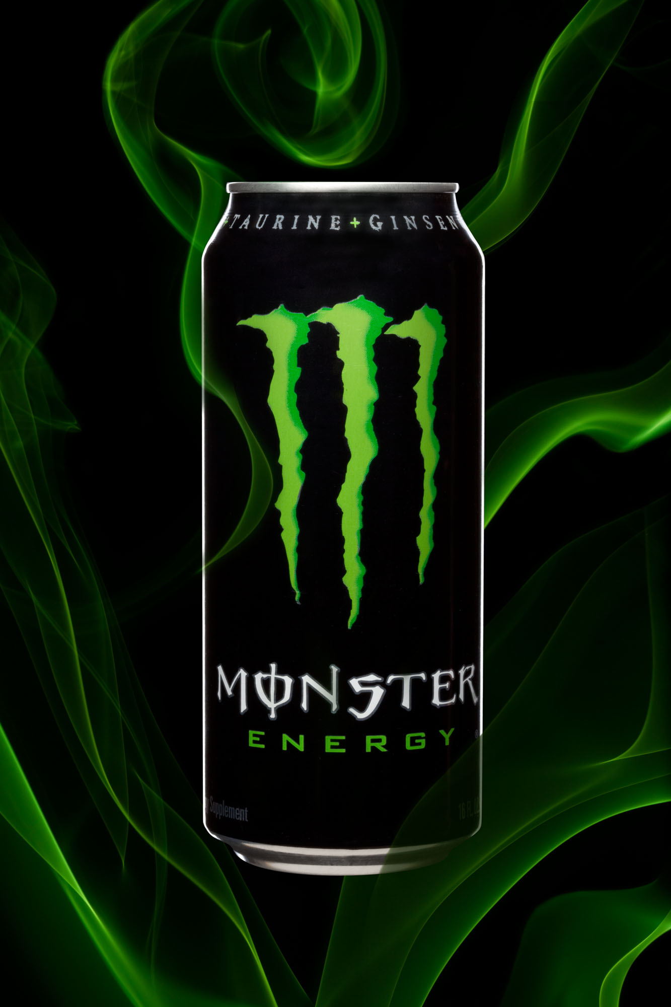 Studio product photography of a Monster Energy drink can with green smoke.