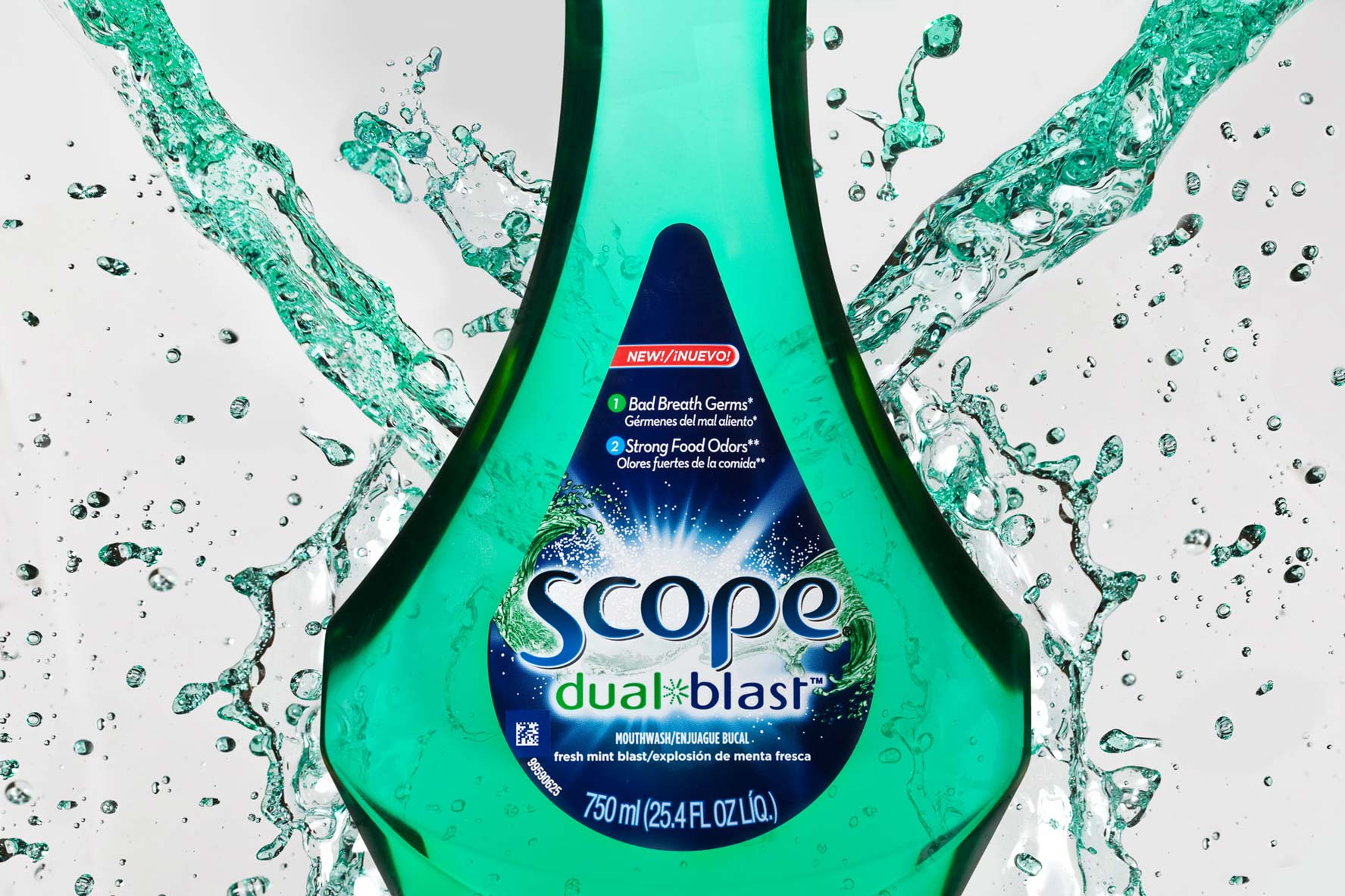 Commercial product photography featuring a Scope Dual Blast mouthwash bottle with dynamic water splashes