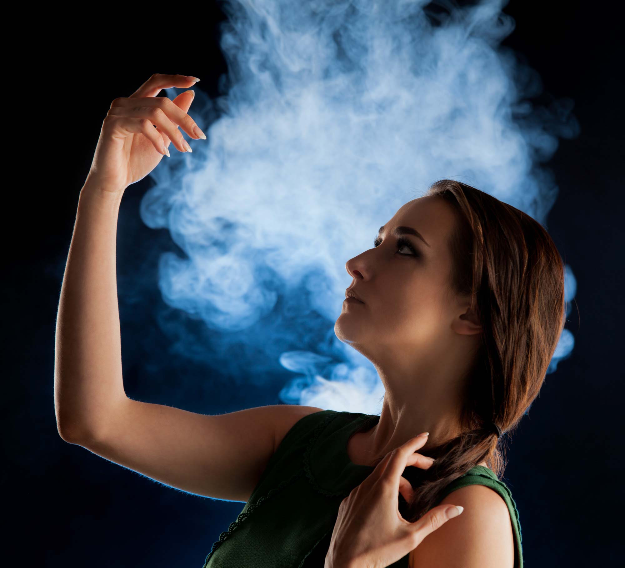 Cinematic portrait of a woman illuminated against a smoky background