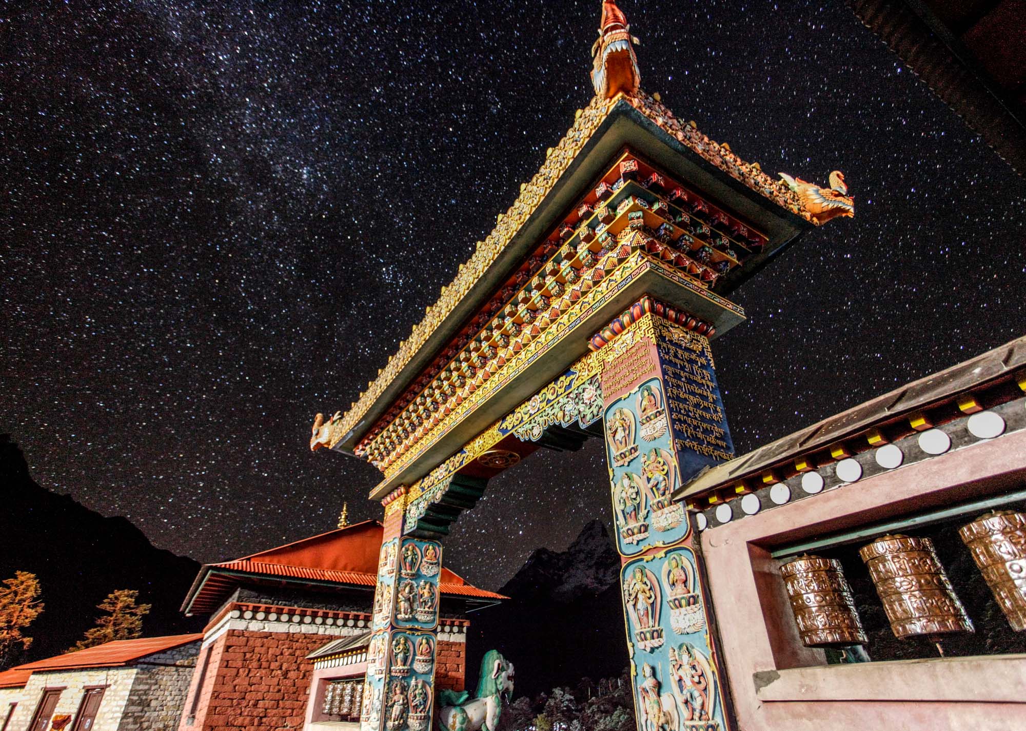 Tengboche Monastery in Nepal photographed at night under a starry sky