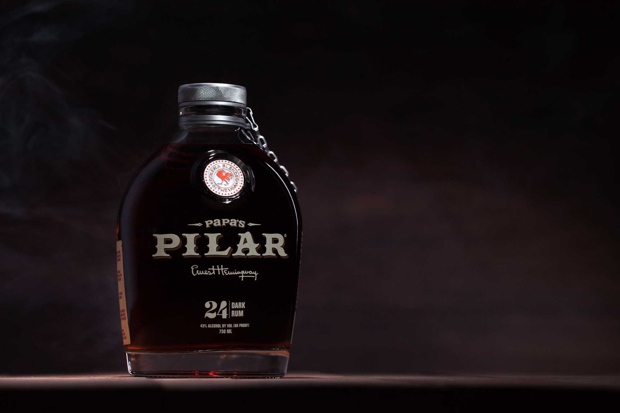 Studio product photography of Papa’s Pilar dark rum bottle on a dark background