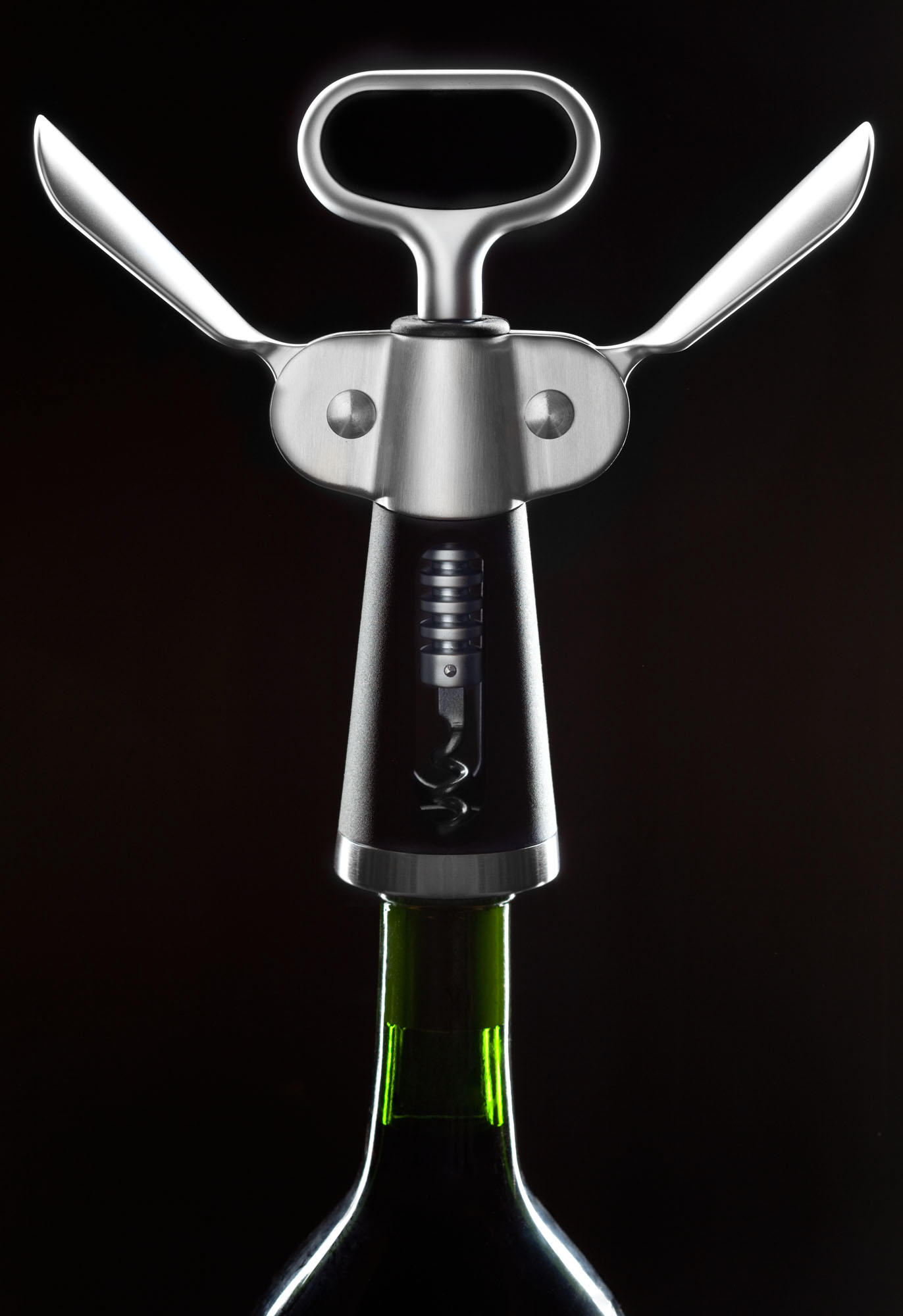 Minimalist product photography of a wine corkscrew against a dark background