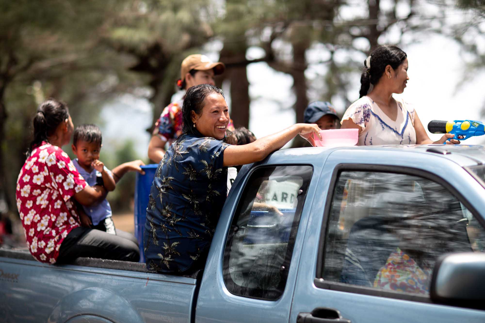 Smiling woman in the back of a truck at Songkran water festival in Phuket, Thailand