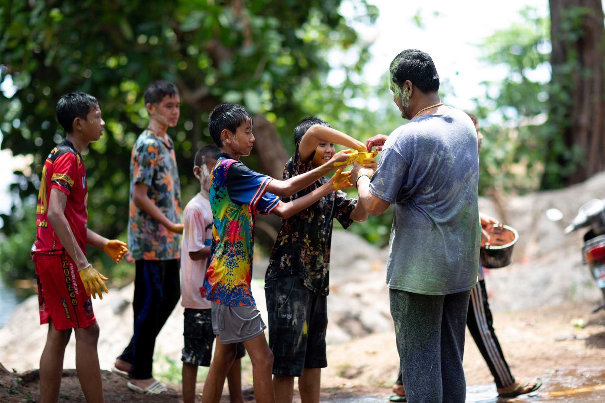 Kids prepare for paint fight at Songkran water festival in Phuket, Thailand