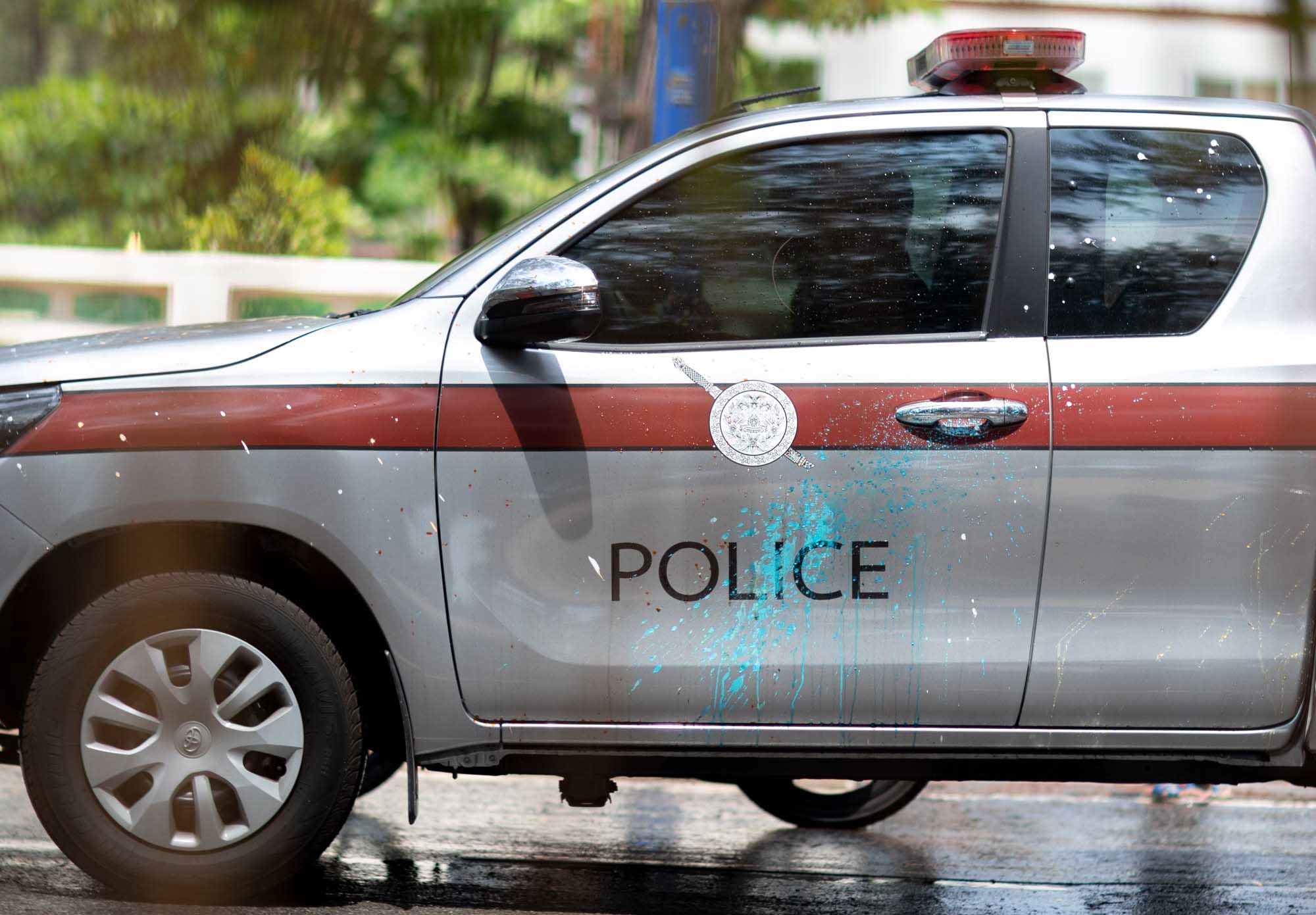 Police vehicle covered in paint during Songkran water festival in Phuket, Thailand