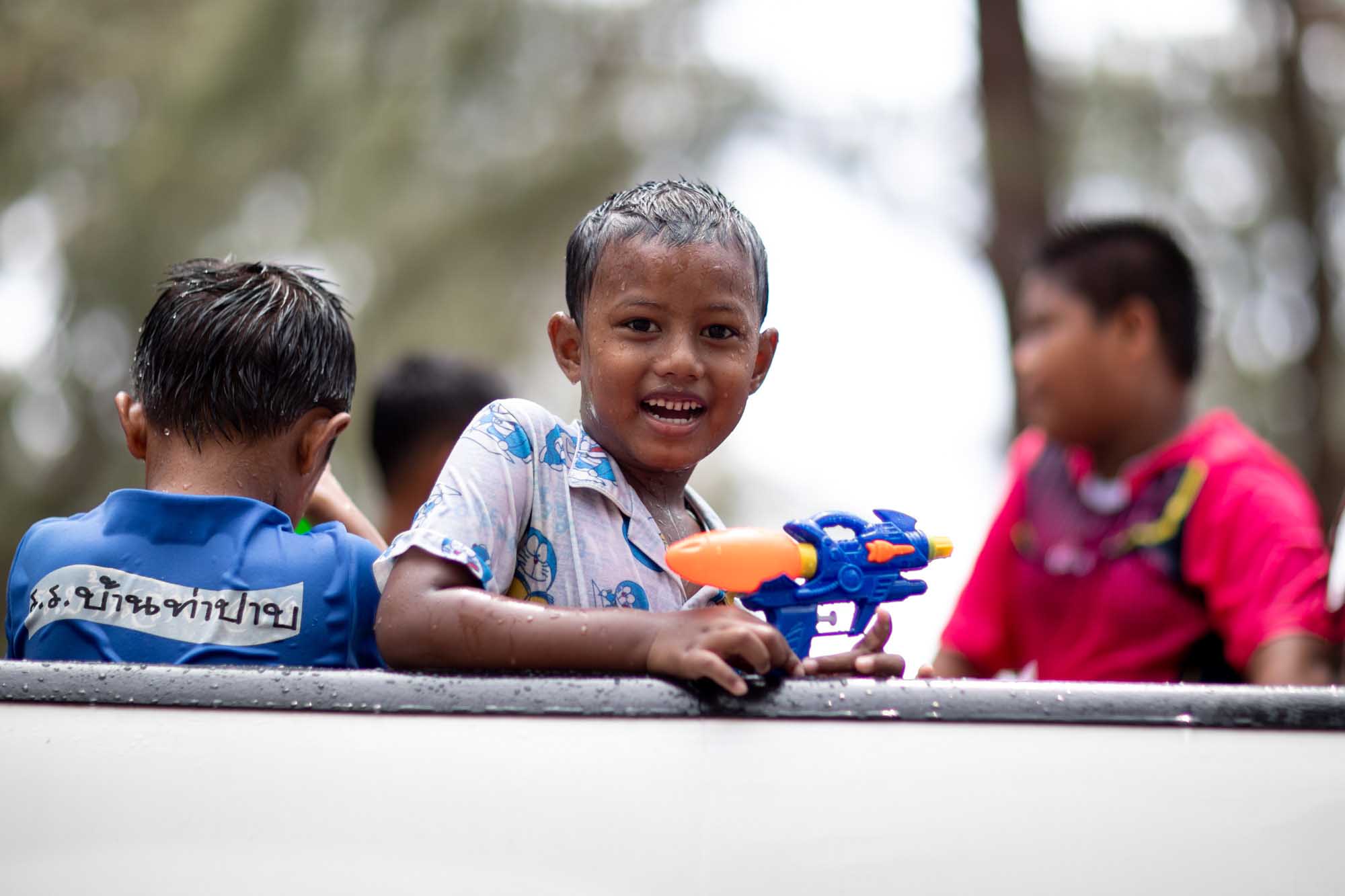 Smiling boy during Songkran water festival in Phuket, Thailand