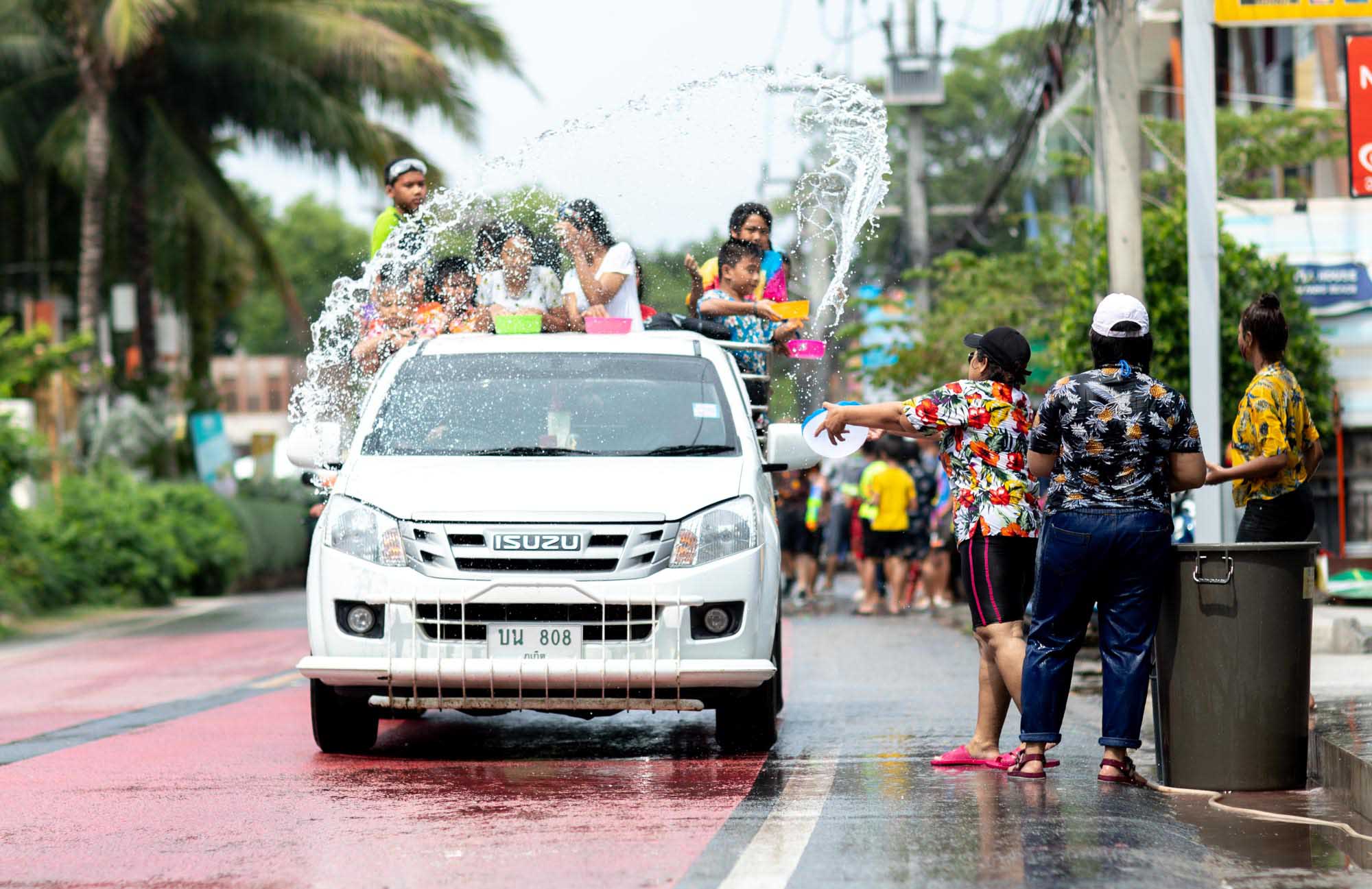 Water flies through the air. Water fight during Songkran water festival in Phuket, Thailand