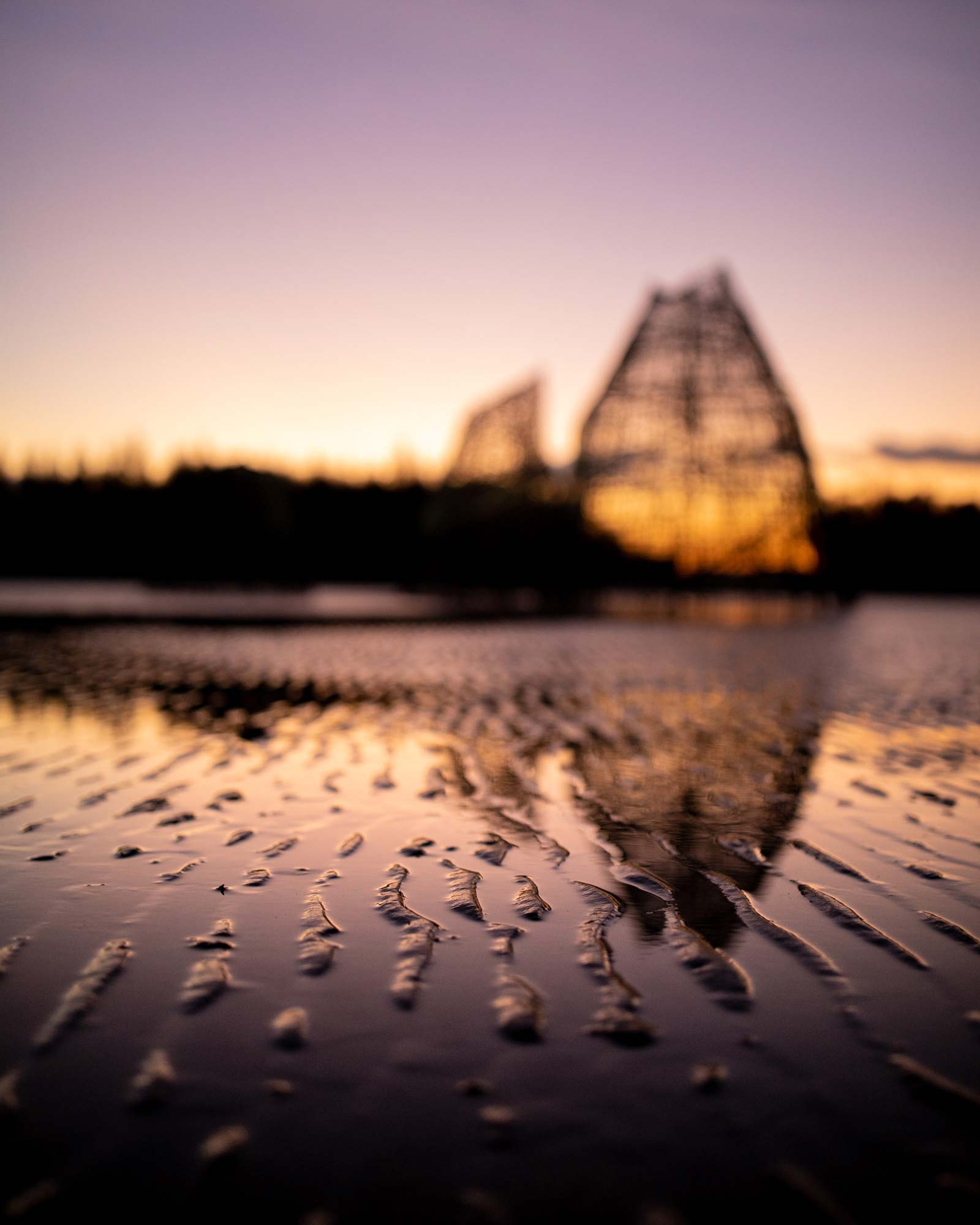 Abstract beach scene featuring a wooden structure in Thailand during golden hour.